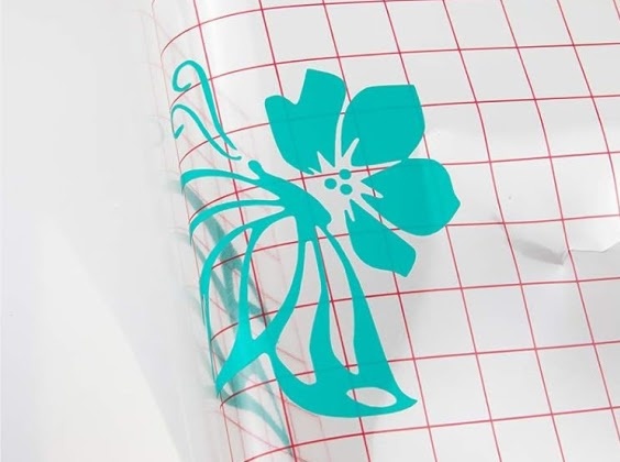 Close-up of a piece of mesh transfer tape pulling a design off the PET carrier.